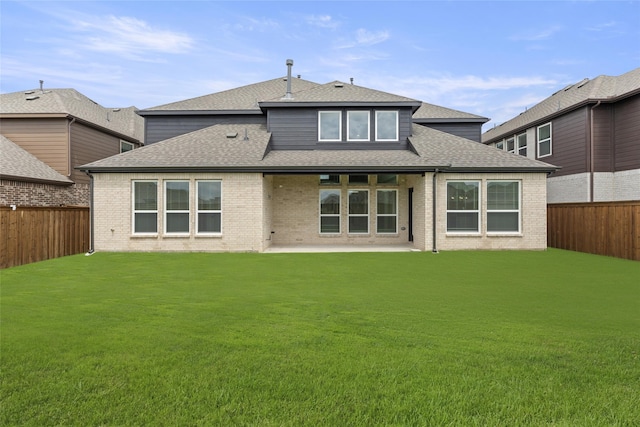 rear view of property with a patio area and a yard