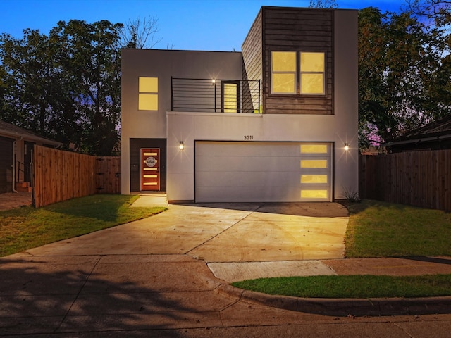 contemporary home featuring a lawn and a garage