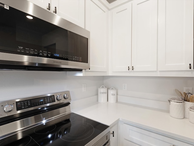 kitchen with white cabinetry and stainless steel appliances