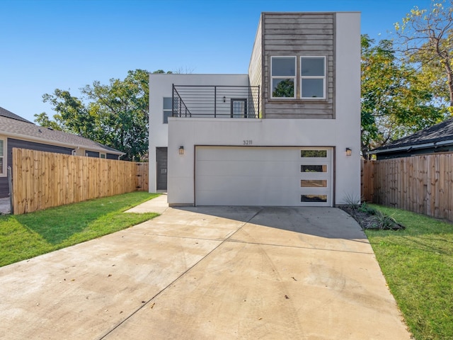 modern home featuring a front lawn and a garage