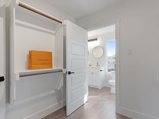 bathroom featuring hardwood / wood-style floors, vanity, and toilet