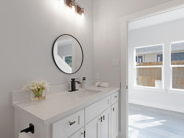 bathroom with hardwood / wood-style flooring and vanity