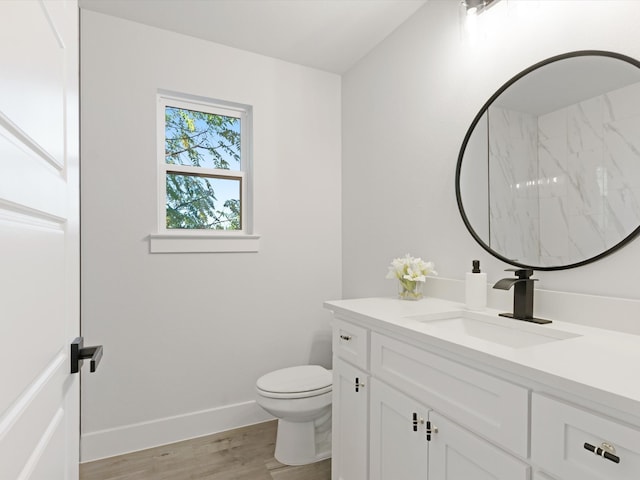 bathroom with hardwood / wood-style flooring, vanity, and toilet