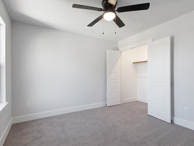 unfurnished bedroom featuring ceiling fan, light carpet, and a closet