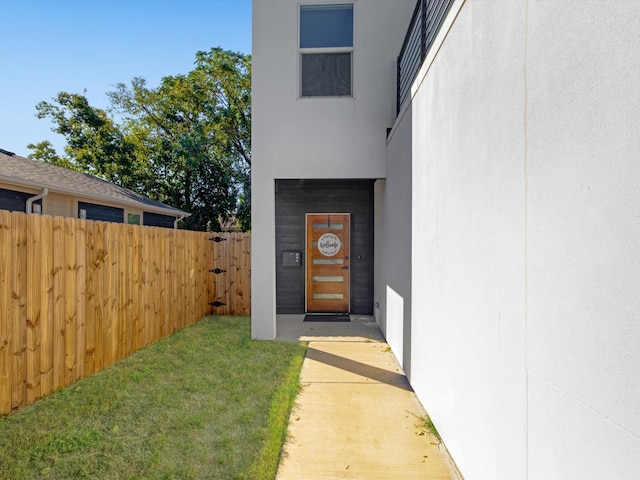 doorway to property with a yard