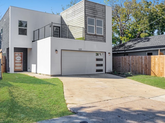 modern home featuring a garage and a front yard