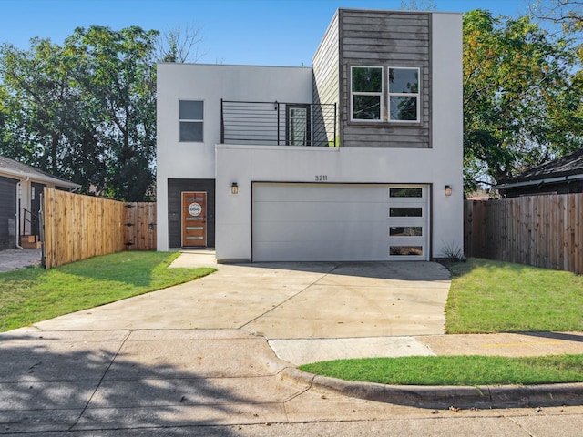 contemporary house with a garage and a front yard