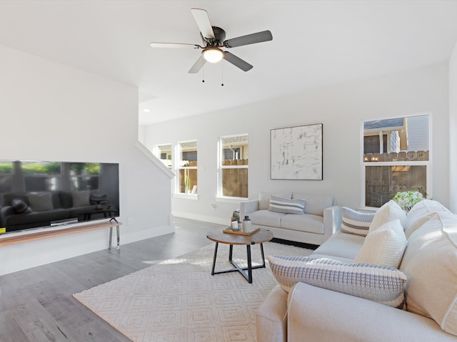 living room featuring hardwood / wood-style flooring and ceiling fan