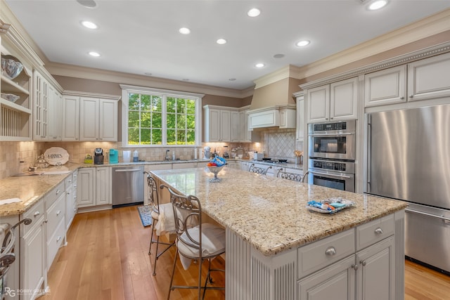 kitchen featuring backsplash, stainless steel appliances, and a center island