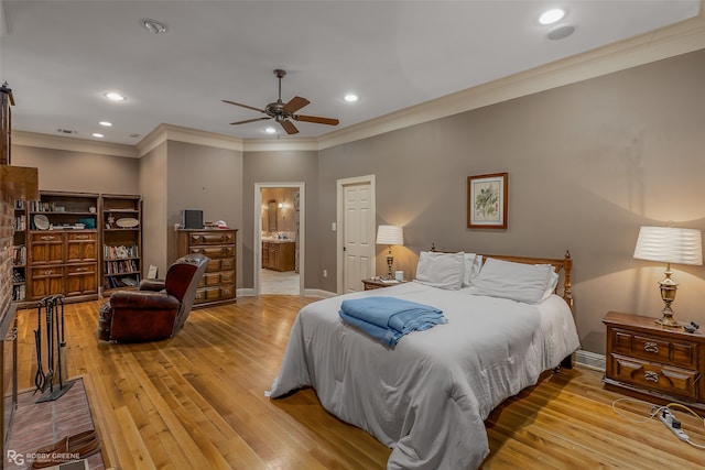 bedroom featuring crown molding, light hardwood / wood-style floors, ceiling fan, and ensuite bathroom