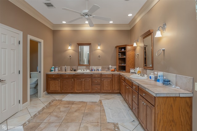 bathroom featuring ceiling fan, crown molding, toilet, tile floors, and dual vanity