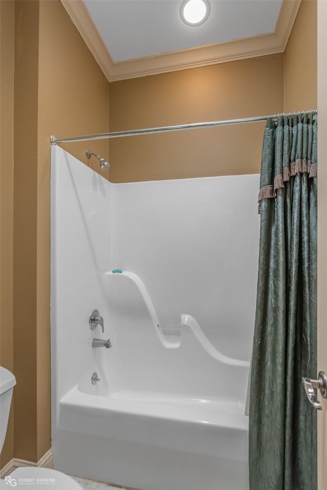 bathroom with ornamental molding, shower / bathtub combination with curtain, and toilet