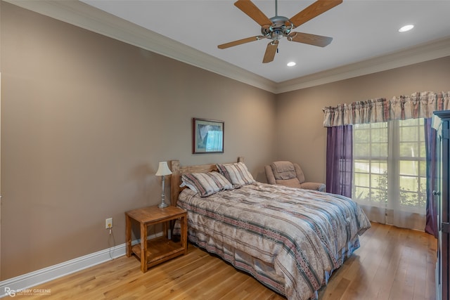 bedroom with ceiling fan, crown molding, and hardwood / wood-style flooring