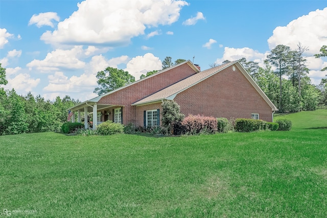 view of home's exterior with a yard