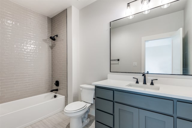 full bathroom featuring vanity, toilet, tile patterned floors, and tiled shower / bath