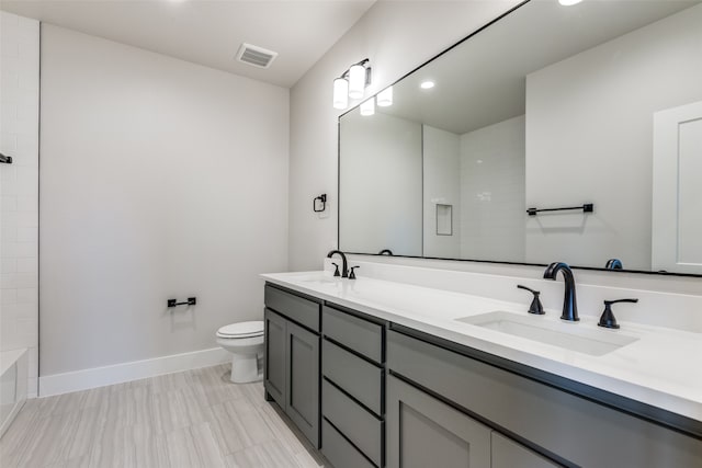 bathroom featuring tile patterned flooring, toilet, walk in shower, and vanity