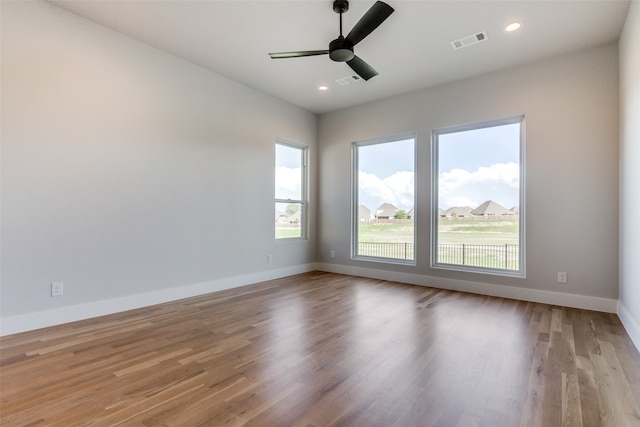 empty room featuring ceiling fan and light hardwood / wood-style flooring