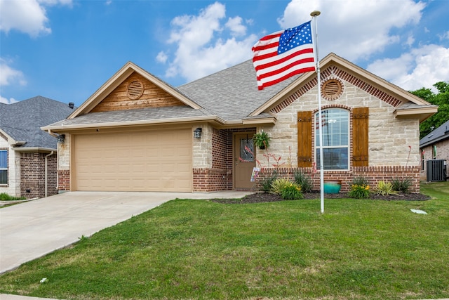 view of front of home with central AC, a garage, and a front yard