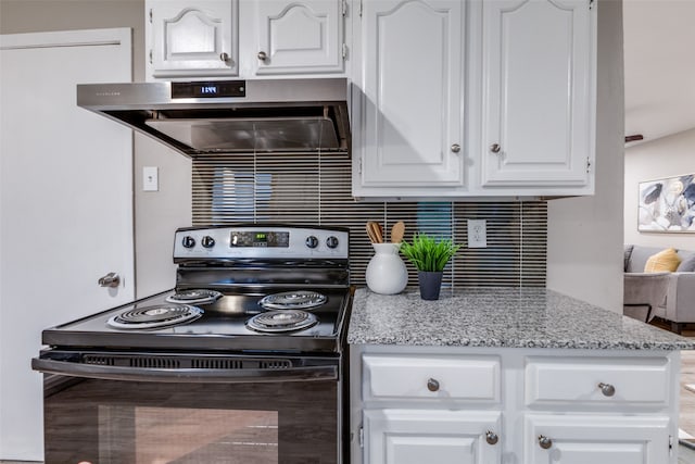 kitchen with light stone countertops, exhaust hood, range with electric stovetop, tasteful backsplash, and white cabinets