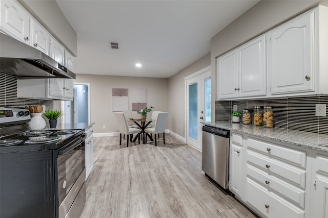 kitchen featuring light stone counters, tasteful backsplash, white cabinetry, stainless steel appliances, and light hardwood / wood-style flooring