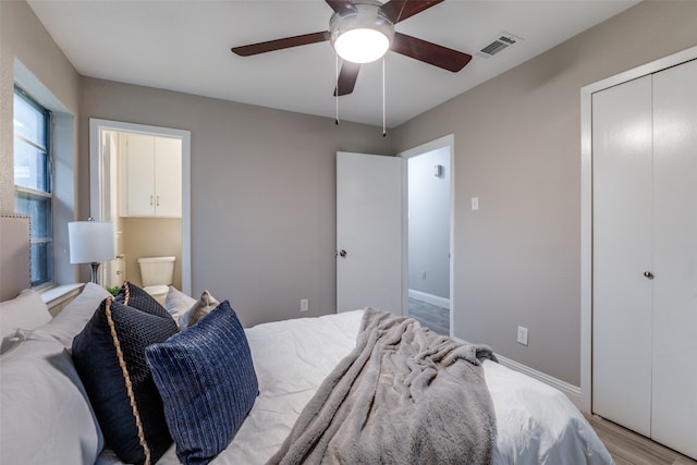 bedroom with connected bathroom, ceiling fan, hardwood / wood-style flooring, and a closet