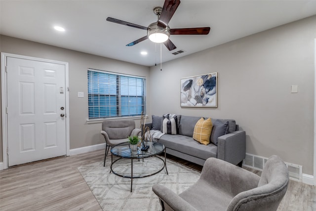 living room featuring ceiling fan and light wood-type flooring