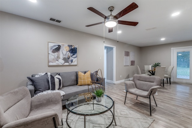 living room featuring ceiling fan and light wood-type flooring