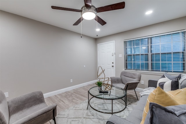 living room with hardwood / wood-style floors and ceiling fan