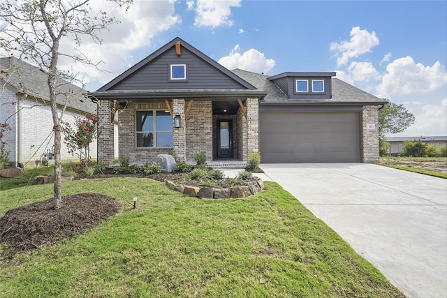 view of front of property featuring covered porch, a front yard, and a garage