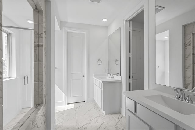 bathroom with vanity and a shower with door