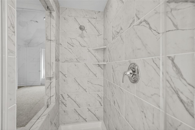 bathroom with a tile shower