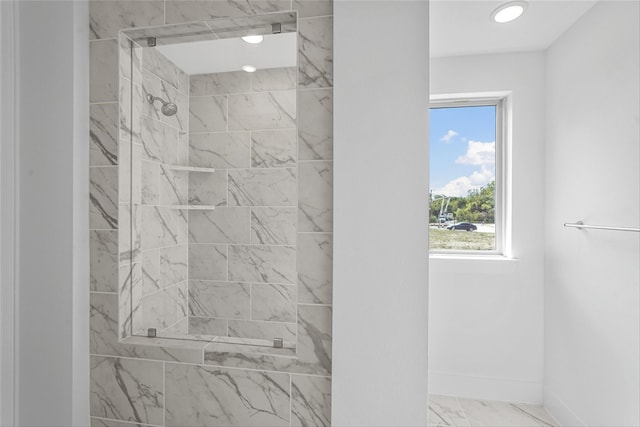 bathroom with a tile shower