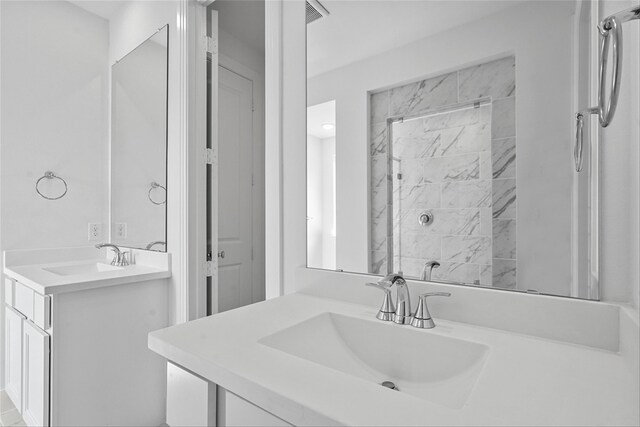 bathroom featuring a tile shower and vanity