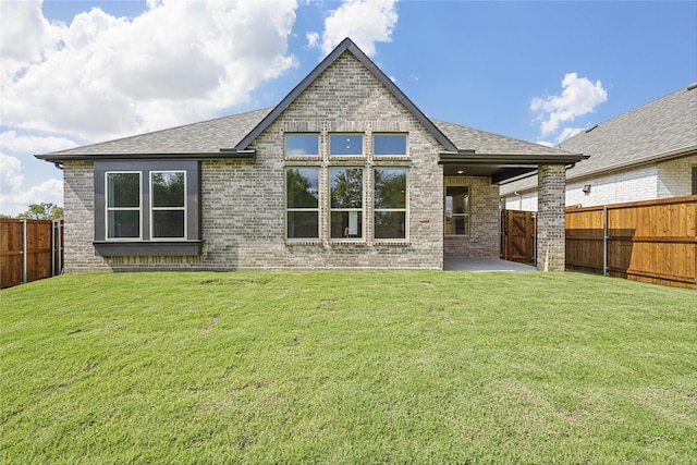 back of house with a yard and a patio area