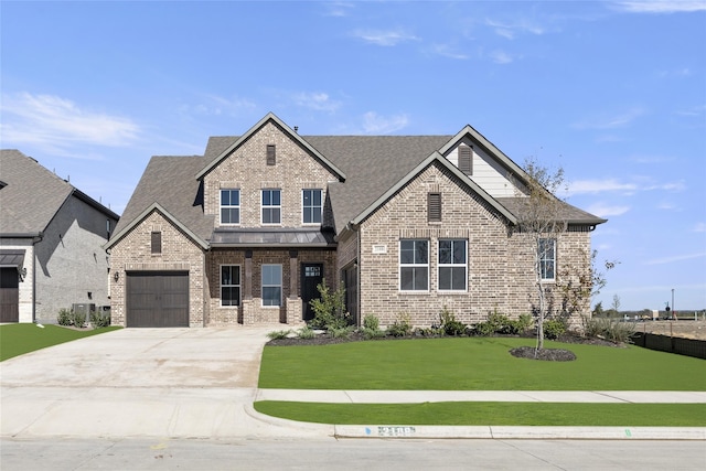 view of front of house featuring a garage and a front yard