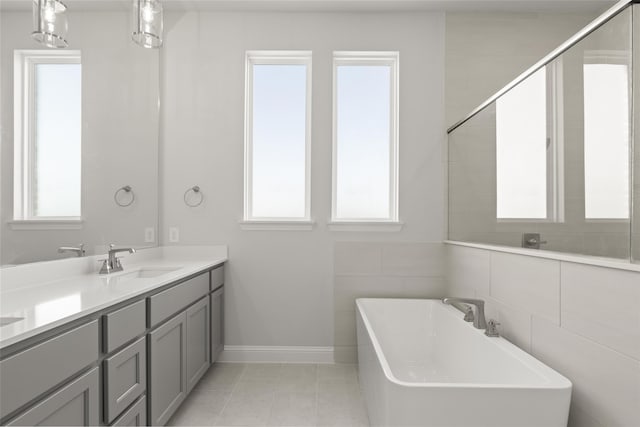 bathroom featuring tile walls, vanity, tile patterned floors, and plus walk in shower