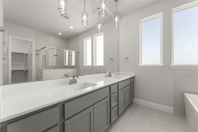 bathroom with vanity, tile patterned floors, and plus walk in shower