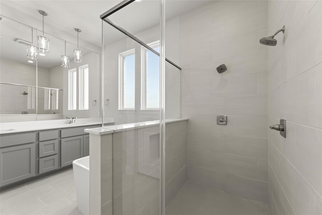 bathroom featuring a shower with door, vanity, and tile patterned flooring