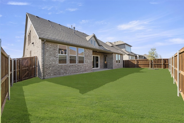 rear view of house featuring a patio and a lawn