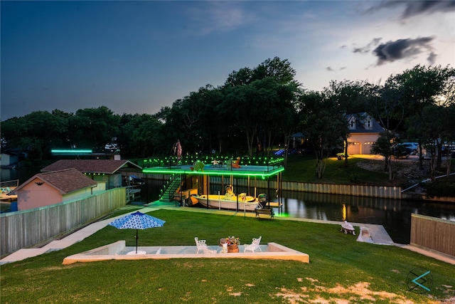 exterior space with a water view and fence