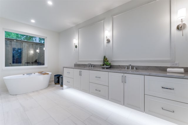 bathroom with vanity and a washtub