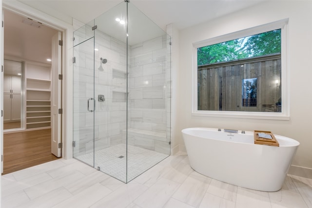 bathroom featuring separate shower and tub and hardwood / wood-style flooring