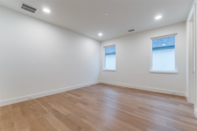 unfurnished room featuring a wealth of natural light and light wood-type flooring