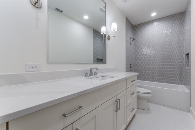 full bathroom with toilet, tiled shower / bath, and vanity