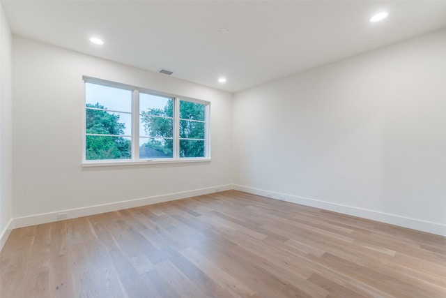 spare room with light hardwood / wood-style flooring