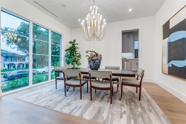 dining room featuring light hardwood / wood-style flooring and a chandelier