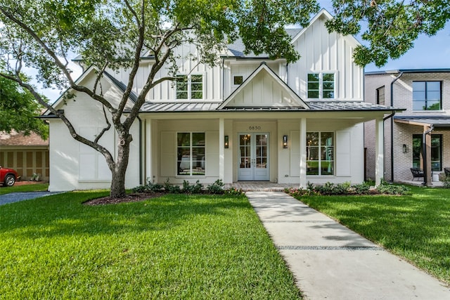 modern inspired farmhouse with a porch and a front lawn