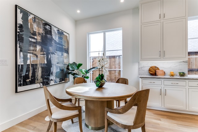 dining space with light wood-type flooring