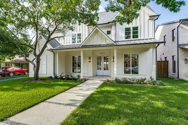 modern farmhouse style home featuring a porch and a front lawn