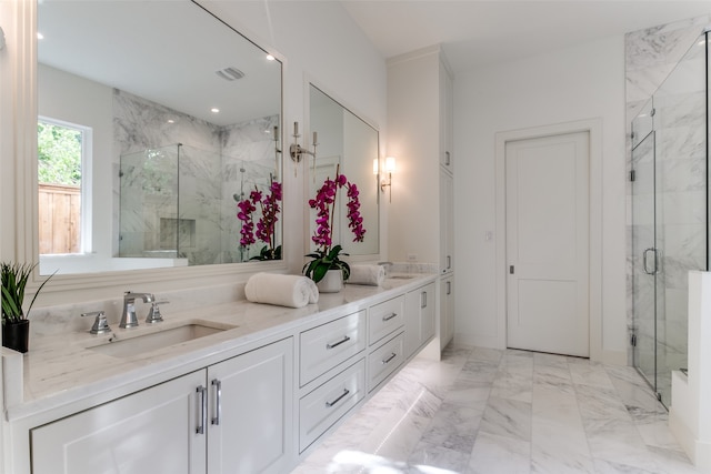 bathroom with vanity and a shower with door